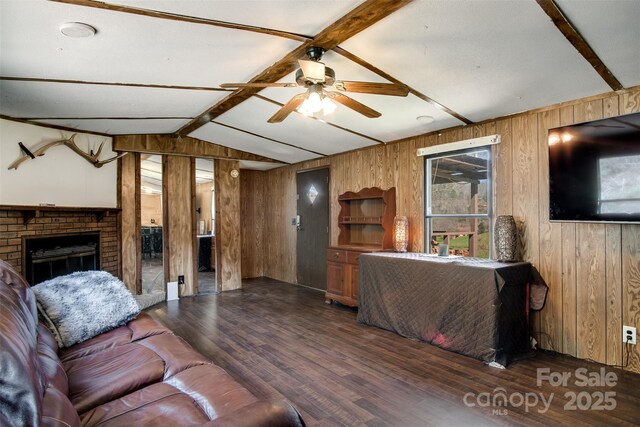 living room featuring vaulted ceiling with beams, ceiling fan, wood finished floors, and wood walls