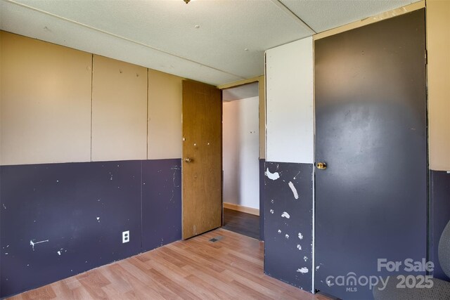 unfurnished room with light wood-style floors