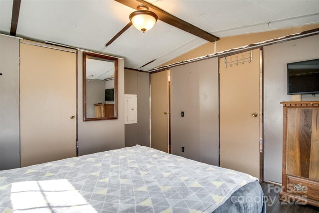 bedroom featuring a closet and vaulted ceiling with beams