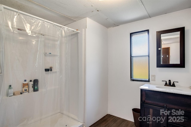 bathroom featuring vanity, a shower with shower curtain, and wood finished floors