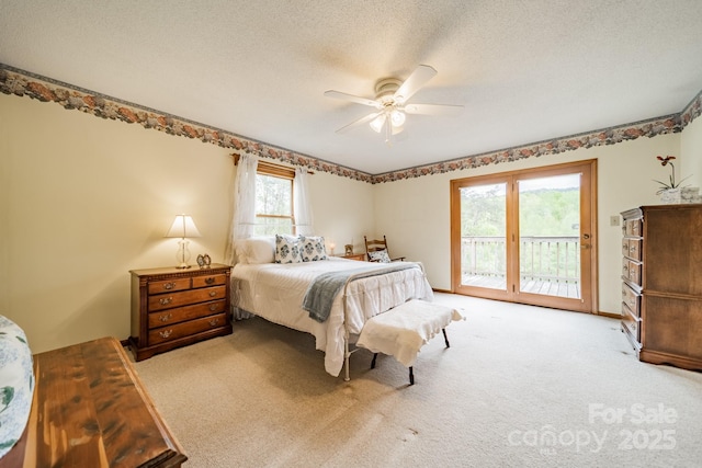 carpeted bedroom featuring a textured ceiling, a ceiling fan, and access to outside