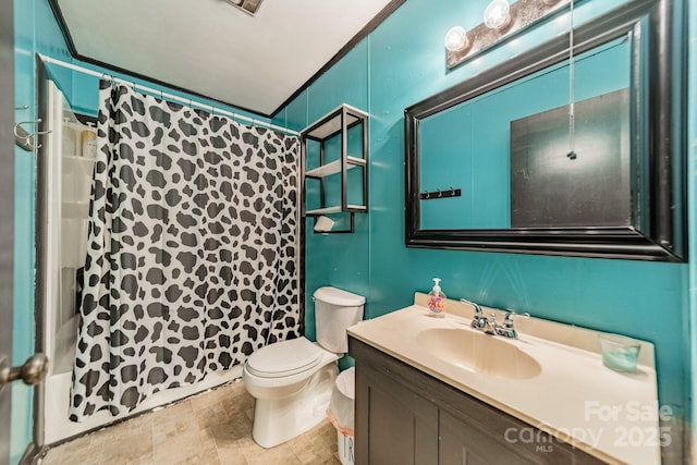 full bath featuring toilet, vanity, and curtained shower