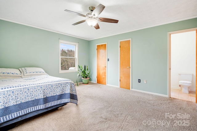 carpeted bedroom with baseboards, ornamental molding, ceiling fan, and connected bathroom
