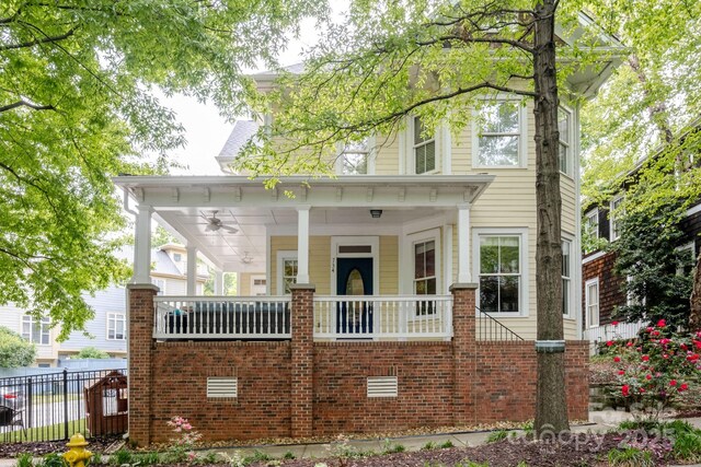 734 E 10th St, Charlotte, NC 28202 - view of front of property with fence, a porch, ceiling fan, and brick siding