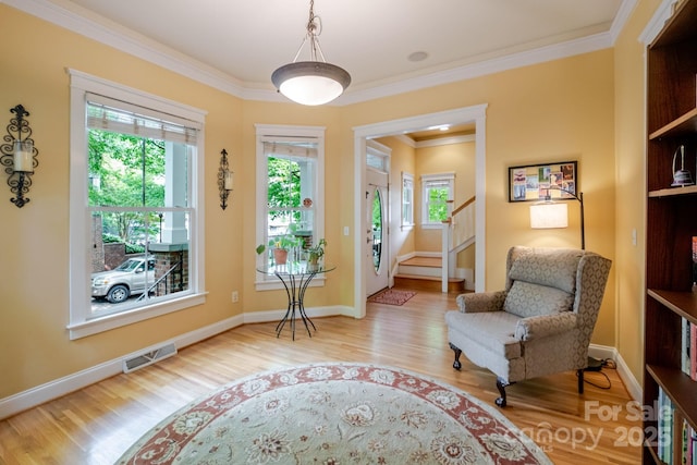 734 E 10th St, Charlotte, NC 28202 - living area featuring crown molding, visible vents, baseboards, wood finished floors, and stairs