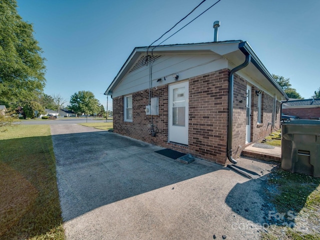 view of side of home with brick siding