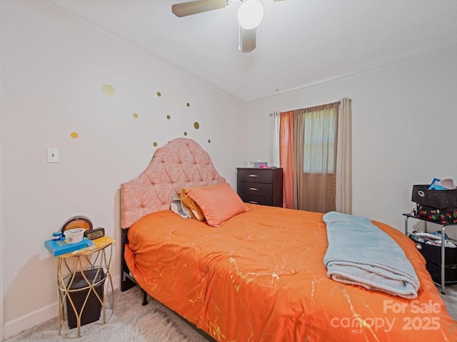 carpeted bedroom with baseboards and ceiling fan