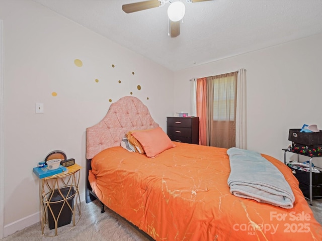 bedroom featuring carpet, baseboards, and a ceiling fan