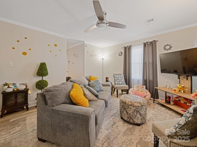 living room with wood finished floors, ceiling fan, ornamental molding, and a textured ceiling