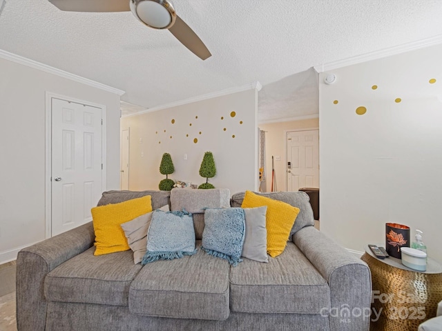 living room featuring ornamental molding, a ceiling fan, and a textured ceiling