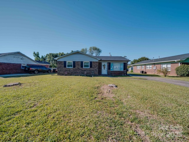 single story home with a front yard and brick siding