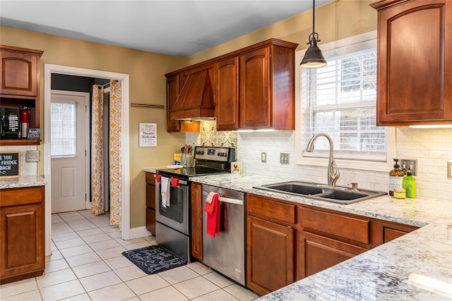 kitchen featuring stainless steel appliances, a sink, light tile patterned floors, and tasteful backsplash