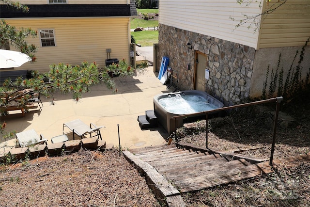 view of patio / terrace with a hot tub