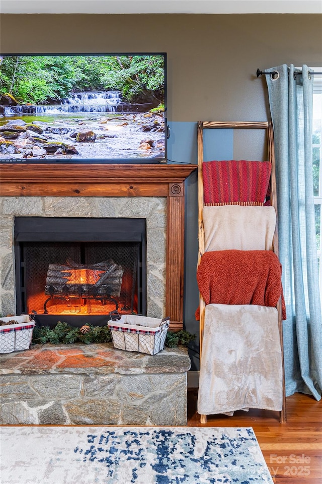 living area with wood finished floors and a fireplace