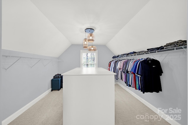 spacious closet featuring light carpet and lofted ceiling