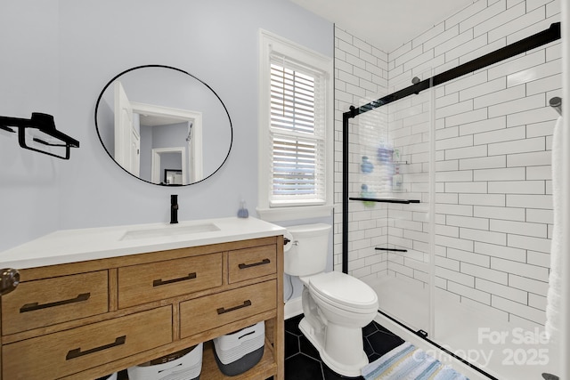 bathroom featuring a shower stall, tile patterned floors, toilet, and vanity