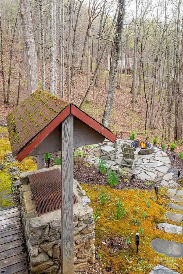 view of home's exterior with a fire pit