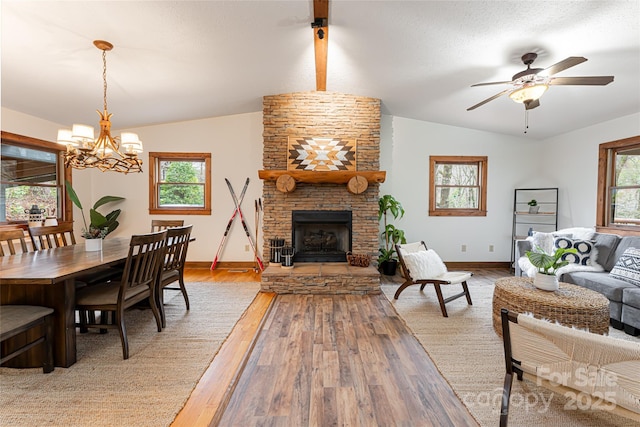39 Antler Springs Way, Maggie Valley, NC 28751 - living room with vaulted ceiling, light wood-style floors, a stone fireplace, baseboards, and a ceiling fan
