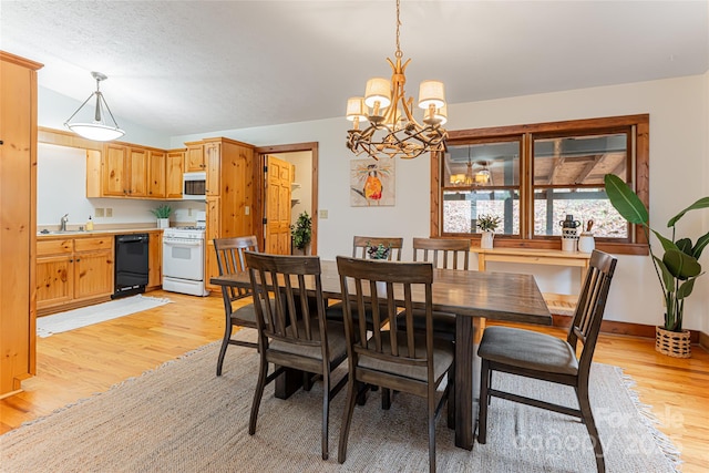 39 Antler Springs Way, Maggie Valley, NC 28751 - dining area with light wood-style floors, a chandelier, and baseboards
