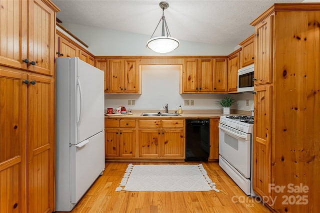 39 Antler Springs Way, Maggie Valley, NC 28751 - kitchen featuring white appliances, a sink, lofted ceiling, light wood finished floors, and light countertops