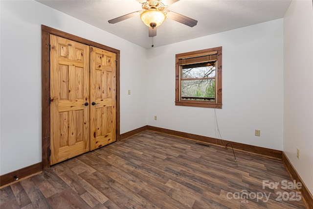 39 Antler Springs Way, Maggie Valley, NC 28751 - unfurnished bedroom featuring dark wood-type flooring, baseboards, and a ceiling fan