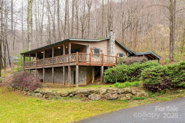 39 Antler Springs Way, Maggie Valley, NC 28751 - view of front of property featuring a chimney, stone siding, a forest view, and a deck