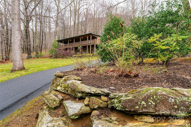 39 Antler Springs Way, Maggie Valley, NC 28751 - view of front of property with a front yard, a wooden deck, and a forest view