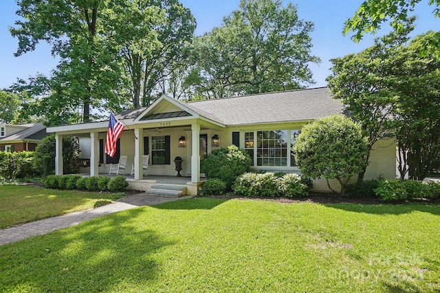 view of front of home featuring covered porch and a front lawn