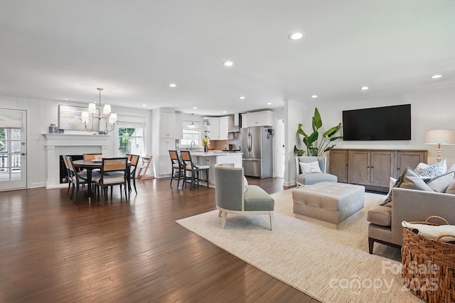 living room with a healthy amount of sunlight, recessed lighting, and dark wood-type flooring