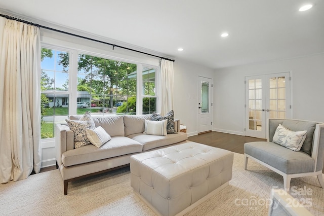 living area with french doors, recessed lighting, baseboards, and wood finished floors