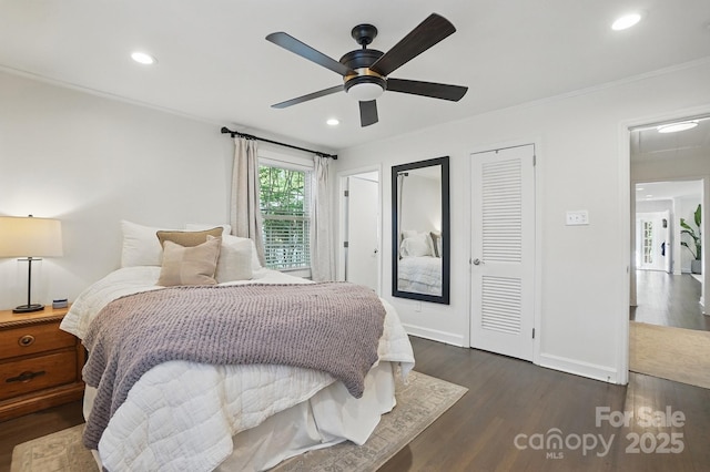 bedroom with recessed lighting, dark wood finished floors, crown molding, and baseboards