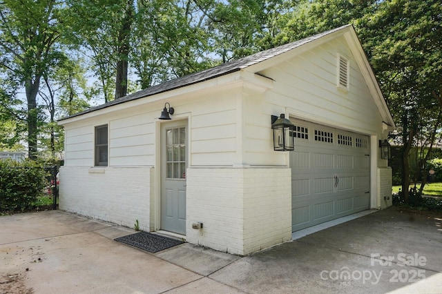 detached garage with concrete driveway