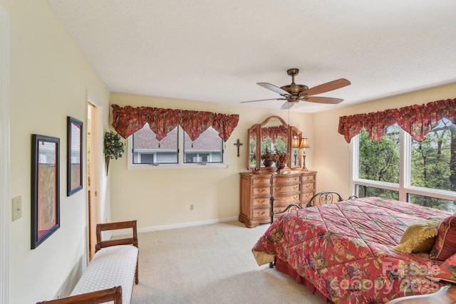 bedroom with a ceiling fan, carpet flooring, and baseboards
