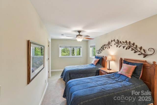 carpeted bedroom featuring baseboards and ceiling fan