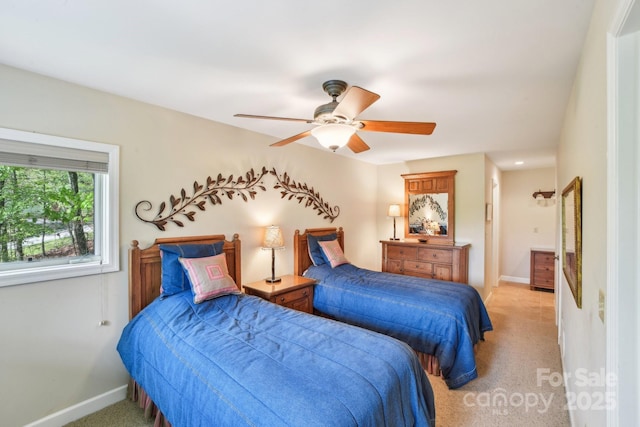bedroom with light carpet, baseboards, and ceiling fan
