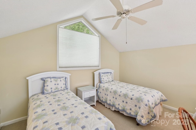 bedroom with vaulted ceiling, baseboards, carpet floors, and a ceiling fan