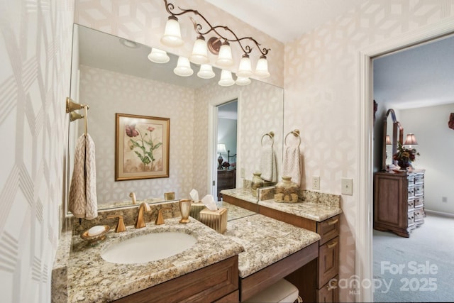 bathroom featuring wallpapered walls and vanity