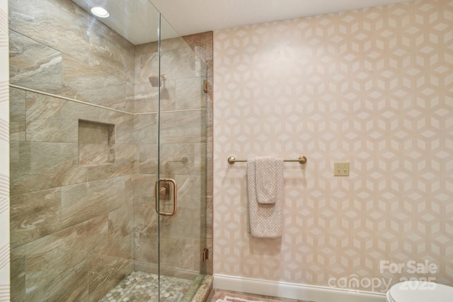 bathroom with toilet and a stall shower
