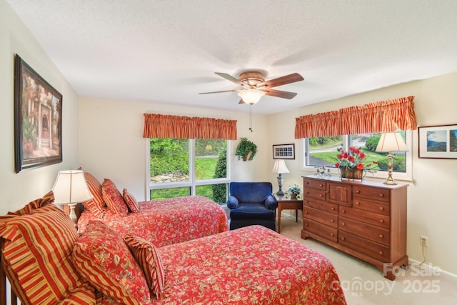bedroom with a ceiling fan and light carpet