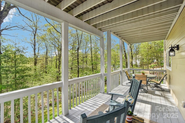 wooden terrace with outdoor dining space