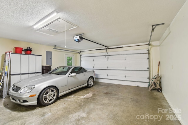 garage with electric panel, baseboards, and a garage door opener