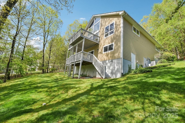 rear view of house featuring a lawn, a wooden deck, ac unit, and stairs
