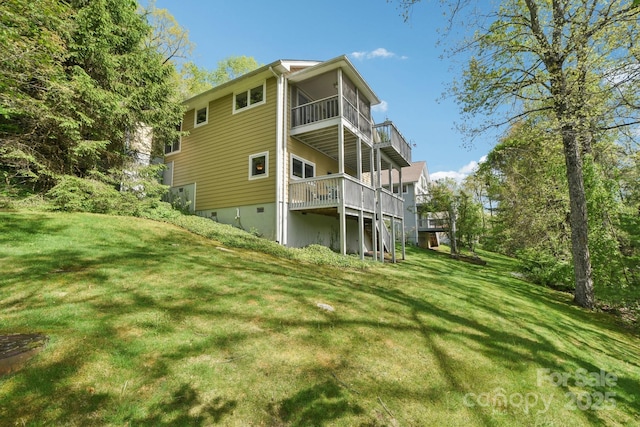rear view of house with a lawn and a wooden deck