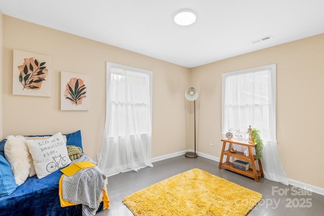 bedroom with visible vents, multiple windows, and baseboards