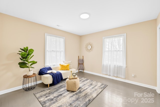 living area featuring visible vents and baseboards