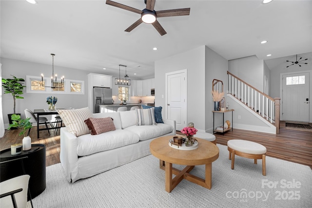 9849 Rich Hatchet Rd, Huntersville, NC 28078 - living area featuring ceiling fan with notable chandelier, recessed lighting, and stairway