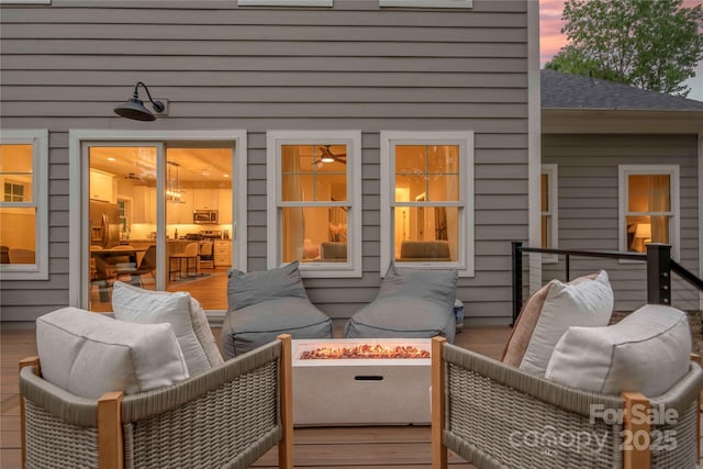 9849 Rich Hatchet Rd, Huntersville, NC 28078 - deck at dusk with an outdoor living space with a fire pit
