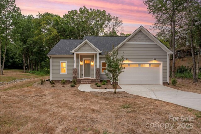 9849 Rich Hatchet Rd, Huntersville, NC 28078 - craftsman-style home with concrete driveway, a garage, a yard, and a shingled roof
