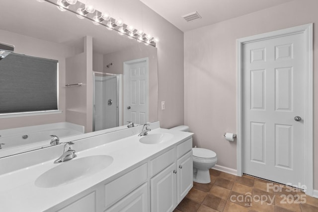 full bath with double vanity, baseboards, a sink, and walk in shower