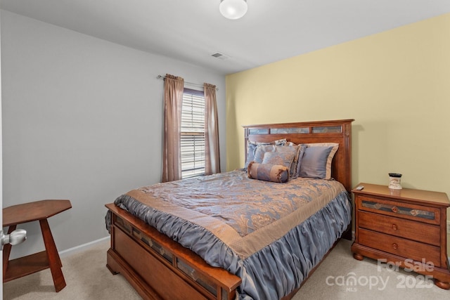 carpeted bedroom with baseboards and visible vents